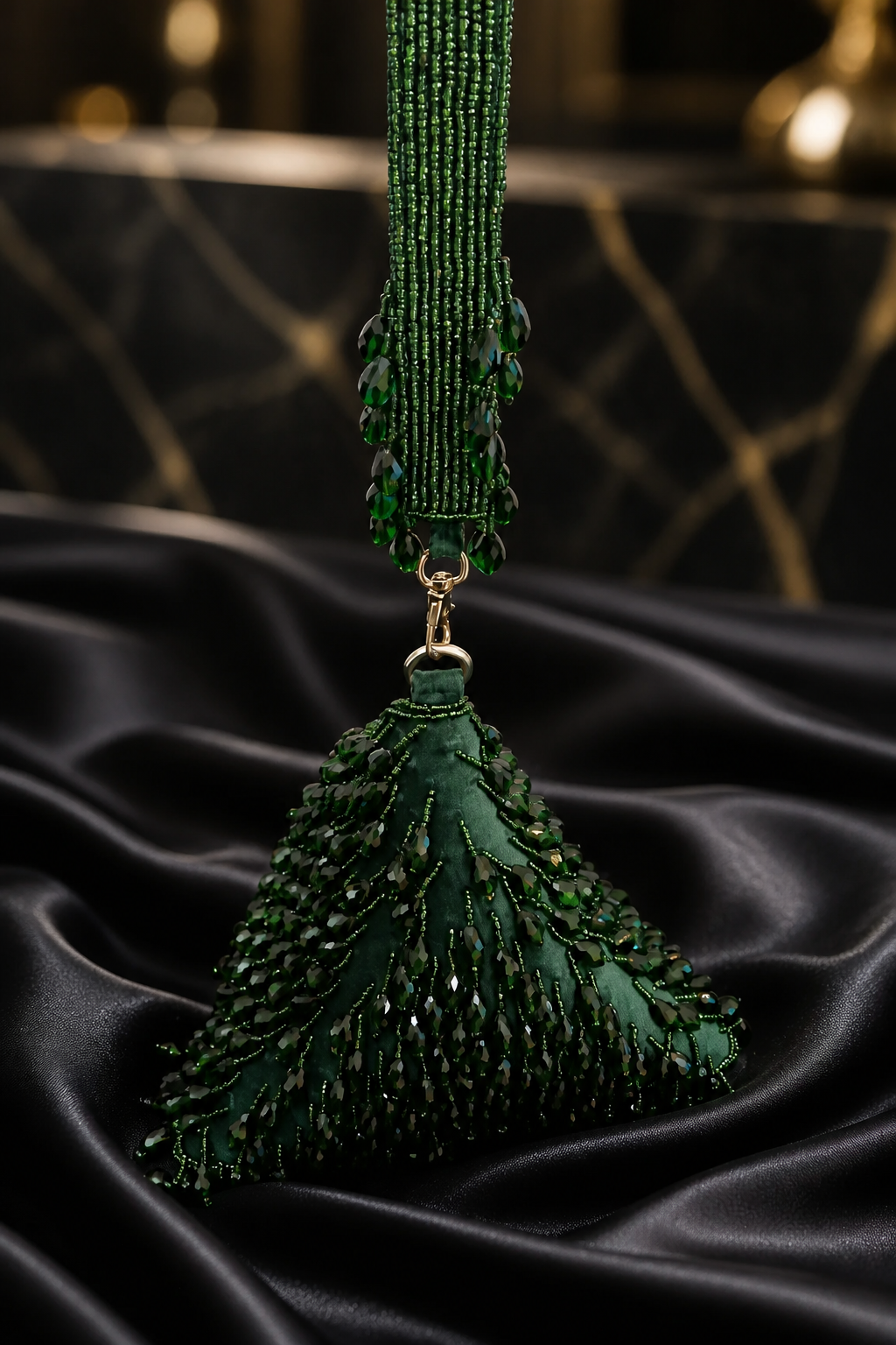 Luxury green beaded wristlet bag with intricate handcrafted beadwork and contemporary triangular design
