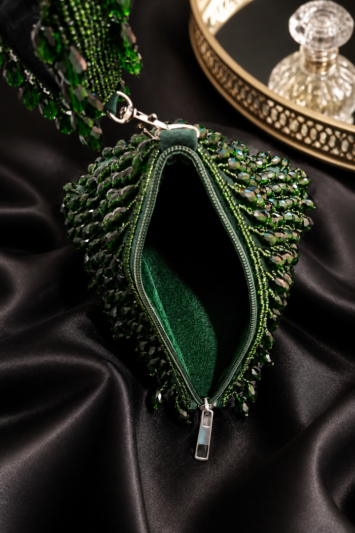 Luxury green beaded wristlet bag with intricate handcrafted beadwork and contemporary triangular design