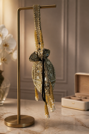 Luxury handcrafted potli bag with mirror embellishments, pearl detailing, embroidery, and elegant tassel fringe design
