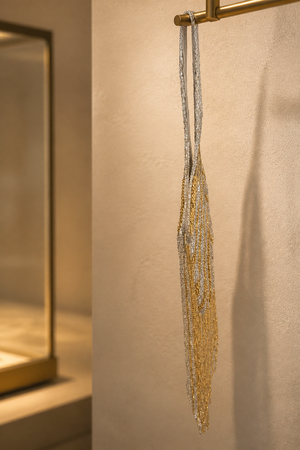 Luxury handcrafted fringe potli bag with gold and silver beadwork and long tassel detailing for party and festive wear