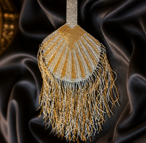Luxury handcrafted fringe potli bag with gold and silver beadwork and long tassel detailing for party and festive wear