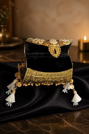 Luxury Alaka mini bag with intricate gold embossed detailing, crystal embellishments, tassels, and metallic handle design