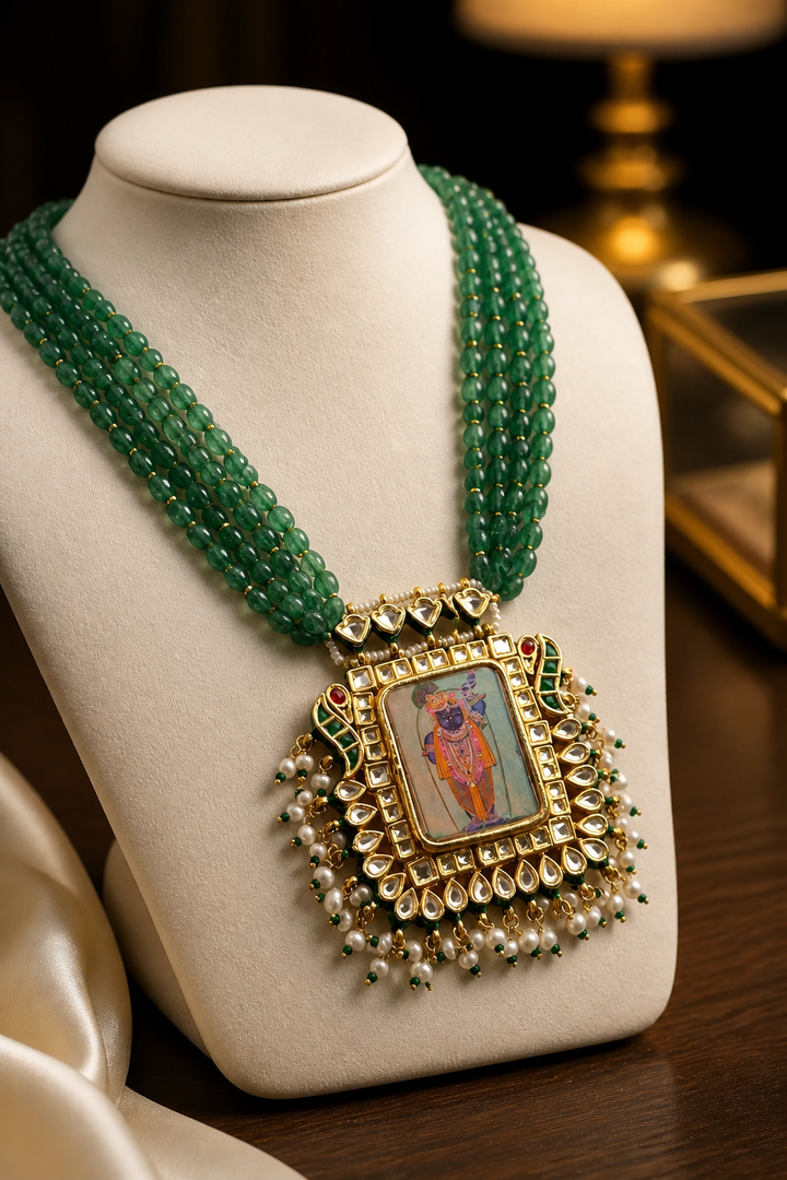 Miniature painting necklace with Shrinath Ji artwork, kundan crystal detailing, and green aventurine bead strands in traditional ethnic style