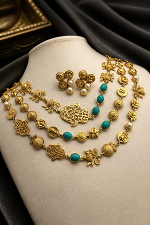 Antique gold layered necklace set with turquoise stones, floral motifs, heritage charms, and matching stud earrings displayed on a jewellery bust