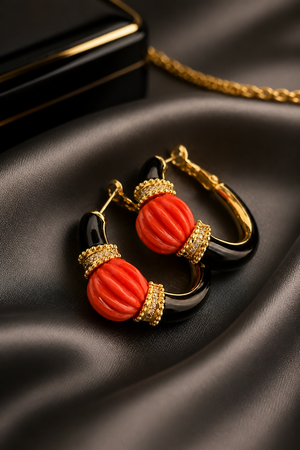 Earring with carved stone with black enamel