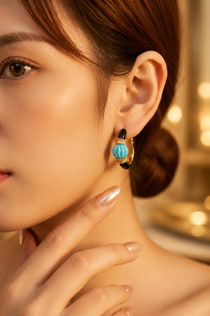 Earring with carved stone with black enamel
