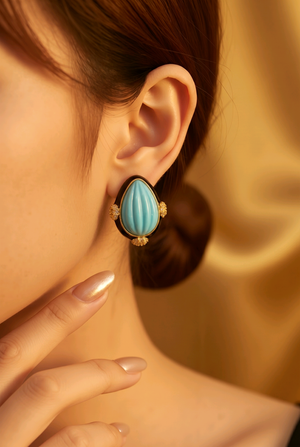 Earring with carved stone with black enamel