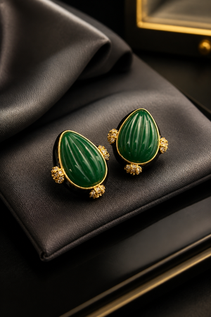 Earring with carved stone with black enamel