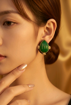 Earring with carved stone with black enamel
