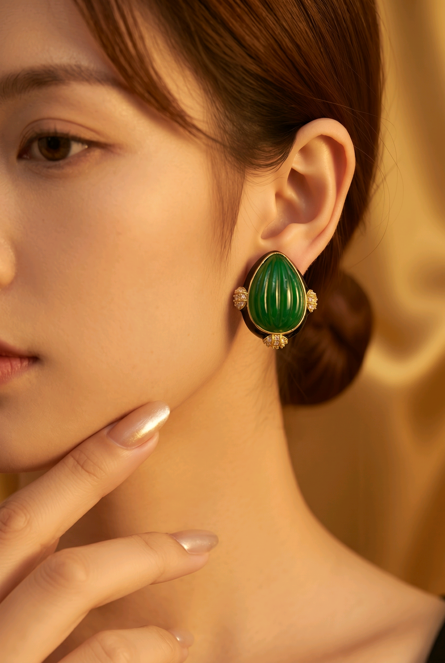 Earring with carved stone with black enamel