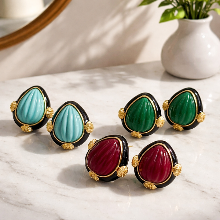 Earring with carved stone with black enamel