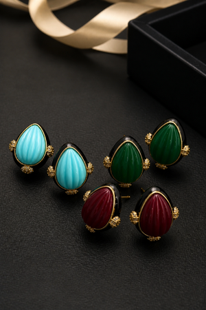 Earring with carved stone with black enamel