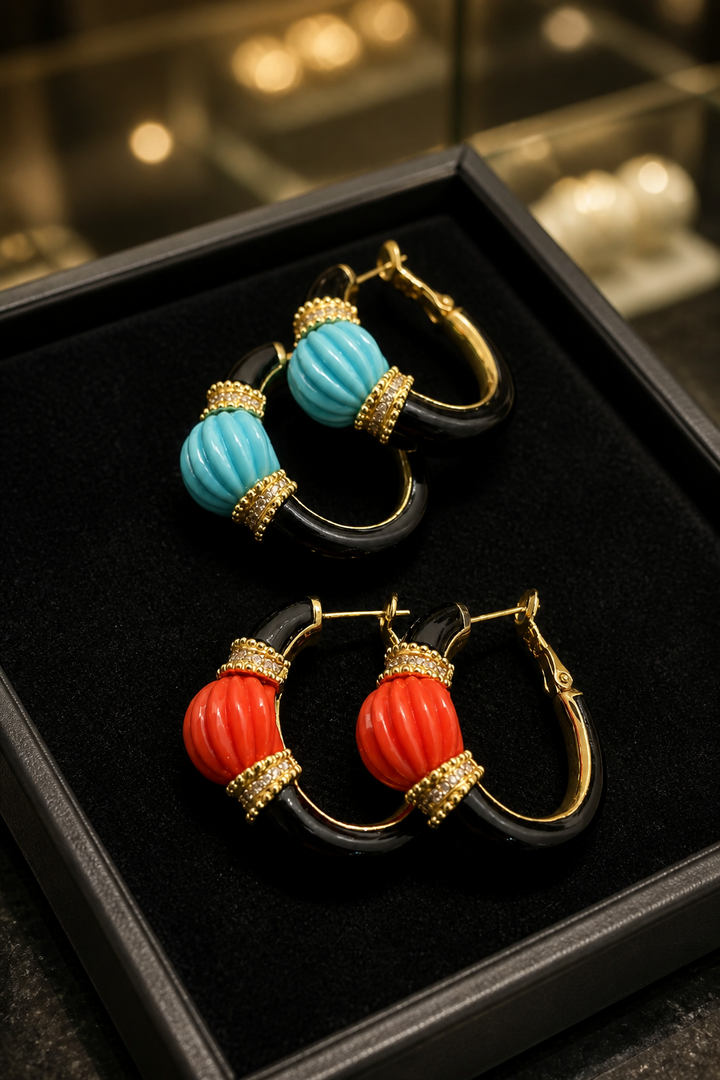 Earring with carved stone with black enamel