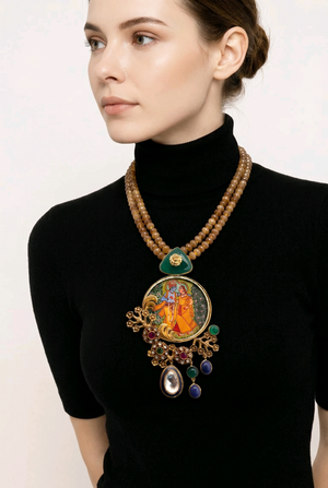 Miniature painting necklace with Radha Krishna artwork, kundan crystal detailing, and brown bead strands in traditional ethnic jewellery style
