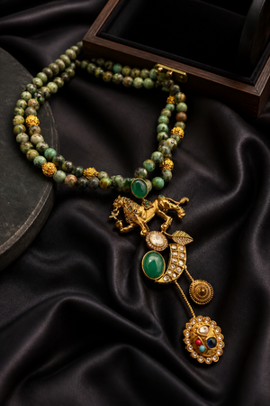 Designer lion motif necklace with kundan crystal detailing and greenish turquoise bead strands in traditional ethnic jewellery style
