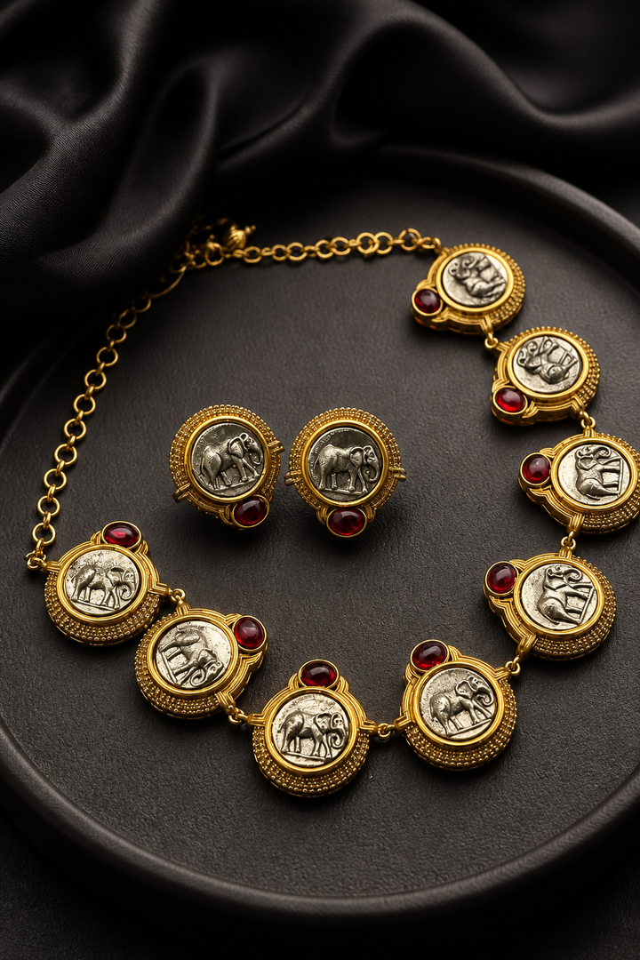 Vintage elephant embossed necklace with red stone accents and two-tone polish detailing with matching earrings in ethnic statement style