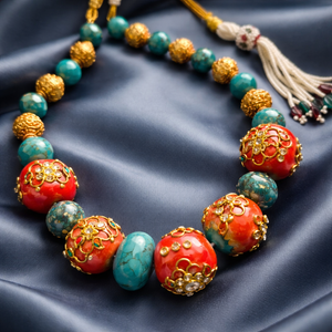 Handcrafted turquoise and coral necklace with intricate jadau work and traditional ethnic designer detailing
