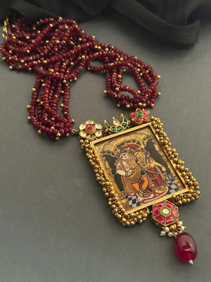 Miniature painting necklace with Radha Krishna artwork, kundan crystal detailing, and ruby quartz bead strands in traditional ethnic style