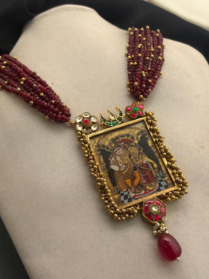 Miniature painting necklace with Radha Krishna artwork, kundan crystal detailing, and ruby quartz bead strands in traditional ethnic style