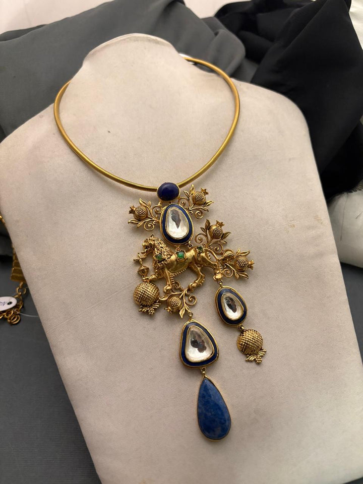 Designer gold hasli necklace with lion motif, kundan crystal detailing, and lapis stone pendant in ethnic statement style