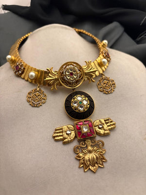 Designer gold necklace with kundan detailing, wooden accents, and traditional statement pendant design