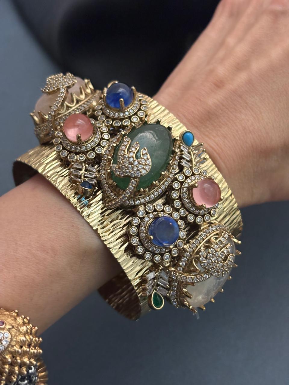 Gold textured ethnic cuff bracelet with coloured stones and AD detailing in traditional designer style