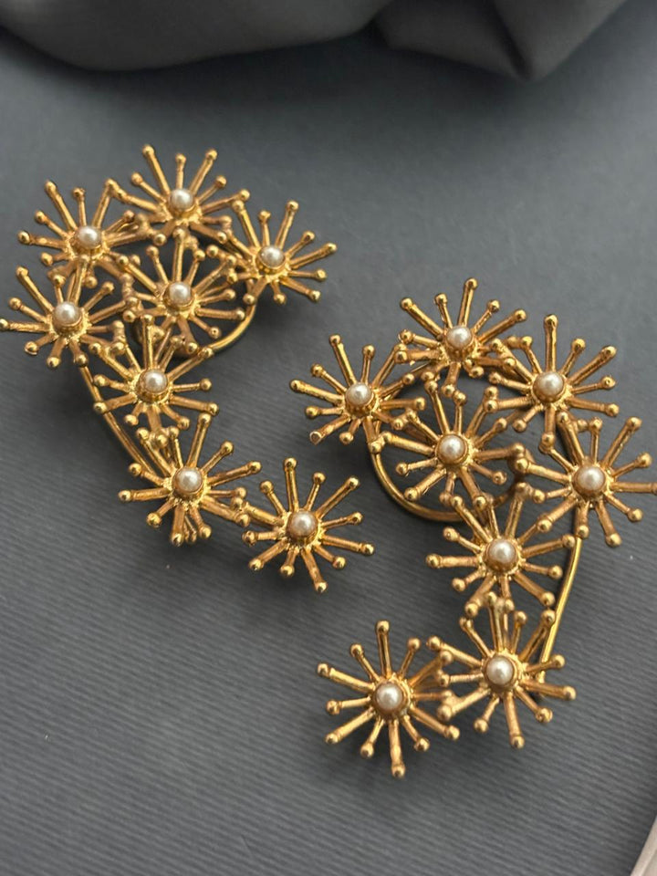 Gold designer ear cuff with shell pearl detailing in modern ethnic jewellery style