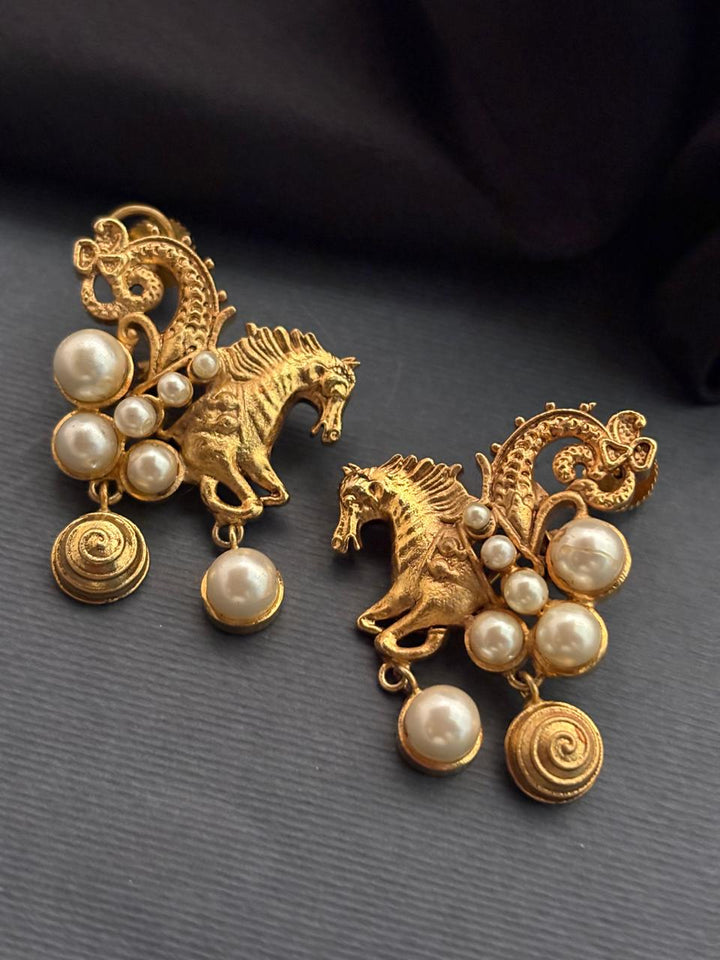 Traditional gold horse motif earrings with shell pearl detailing and intricate ethnic design