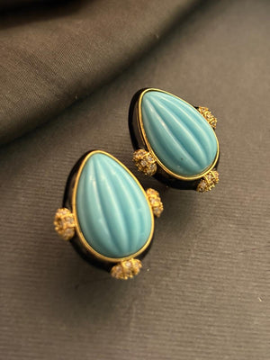 Designer earrings with carved turquise stones and black enamel detailing in elegant ethnic style