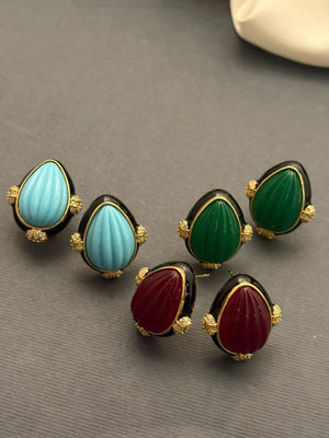 Earring with carved stone with black enamel