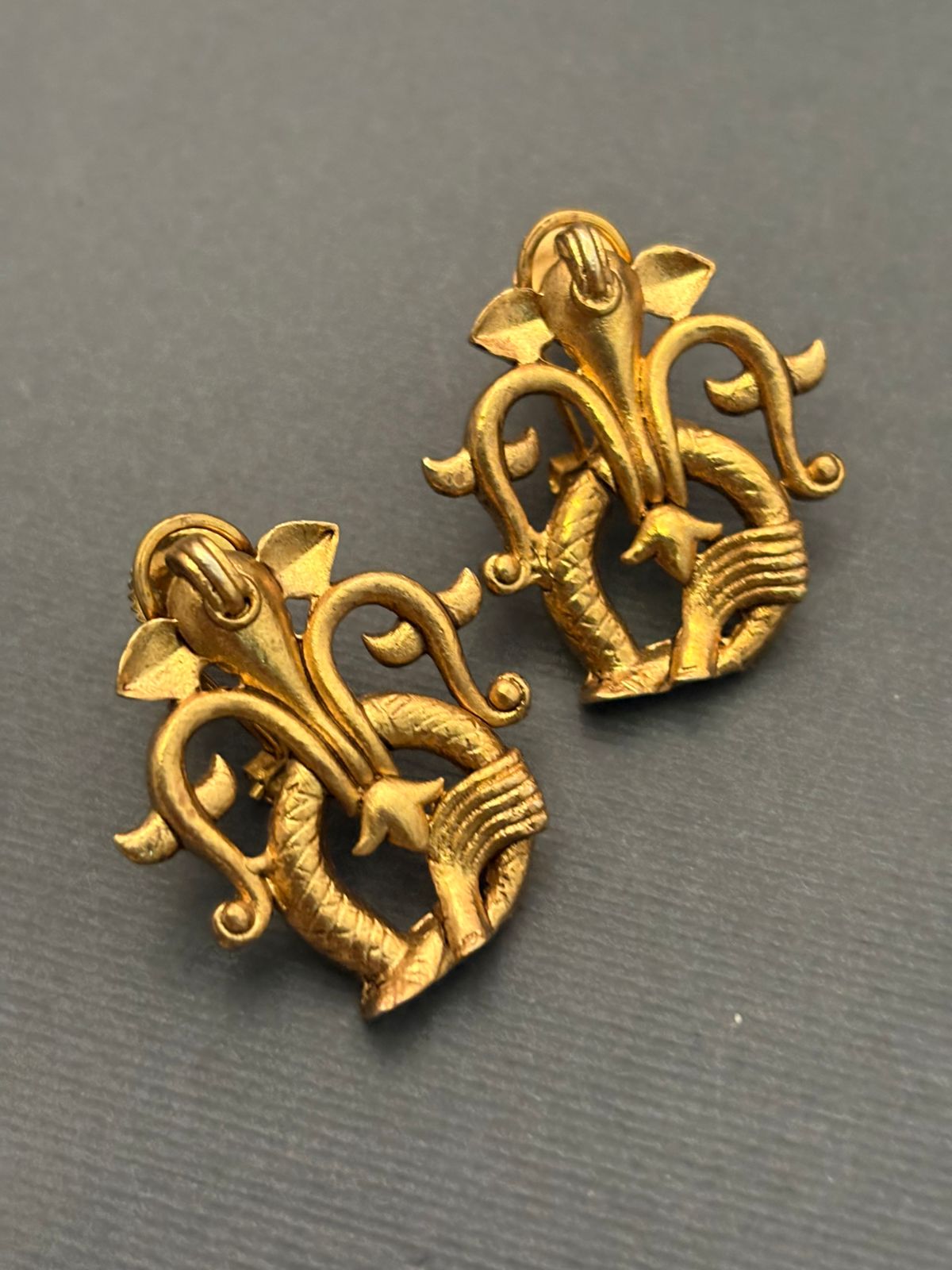 Designer gold earrings with contemporary sculpted pattern and elegant ethnic jewellery finish