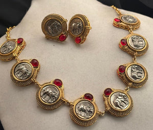 Vintage coin necklace with red stone accents and two tone polish detailing with matching earrings in ethnic statement style