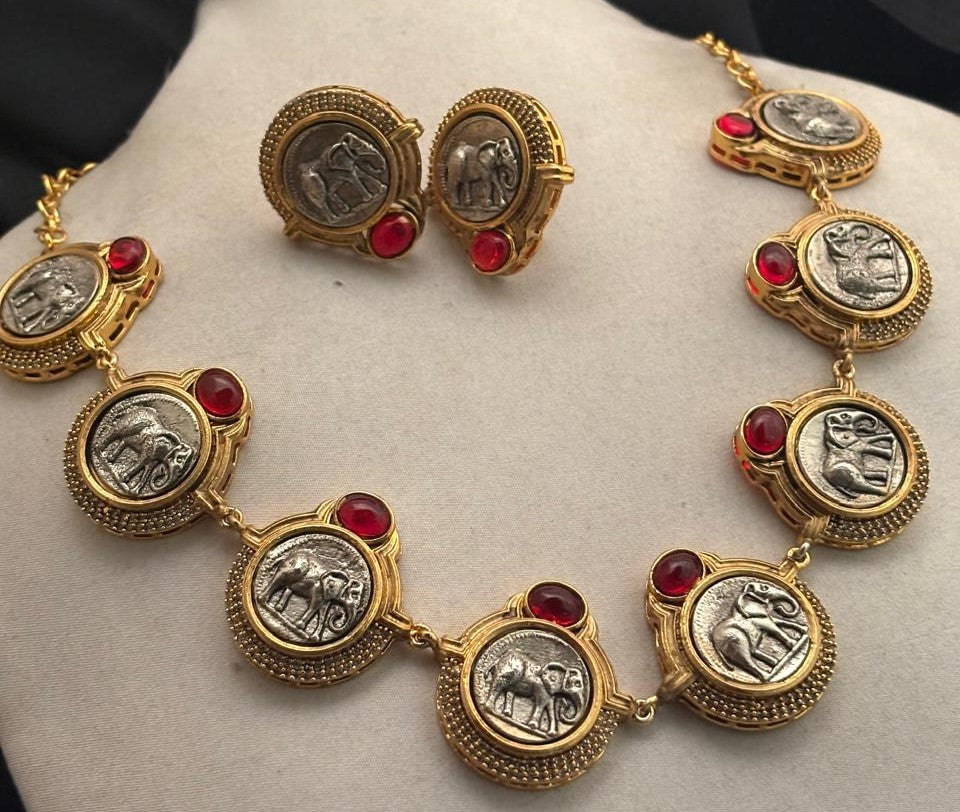 Vintage coin necklace with red stone accents and two tone polish detailing with matching earrings in ethnic statement style