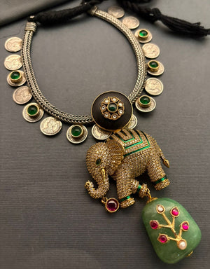 Luxury elephant motif necklace with coin detailing and green jadau stone hanging in traditional ethnic statement design