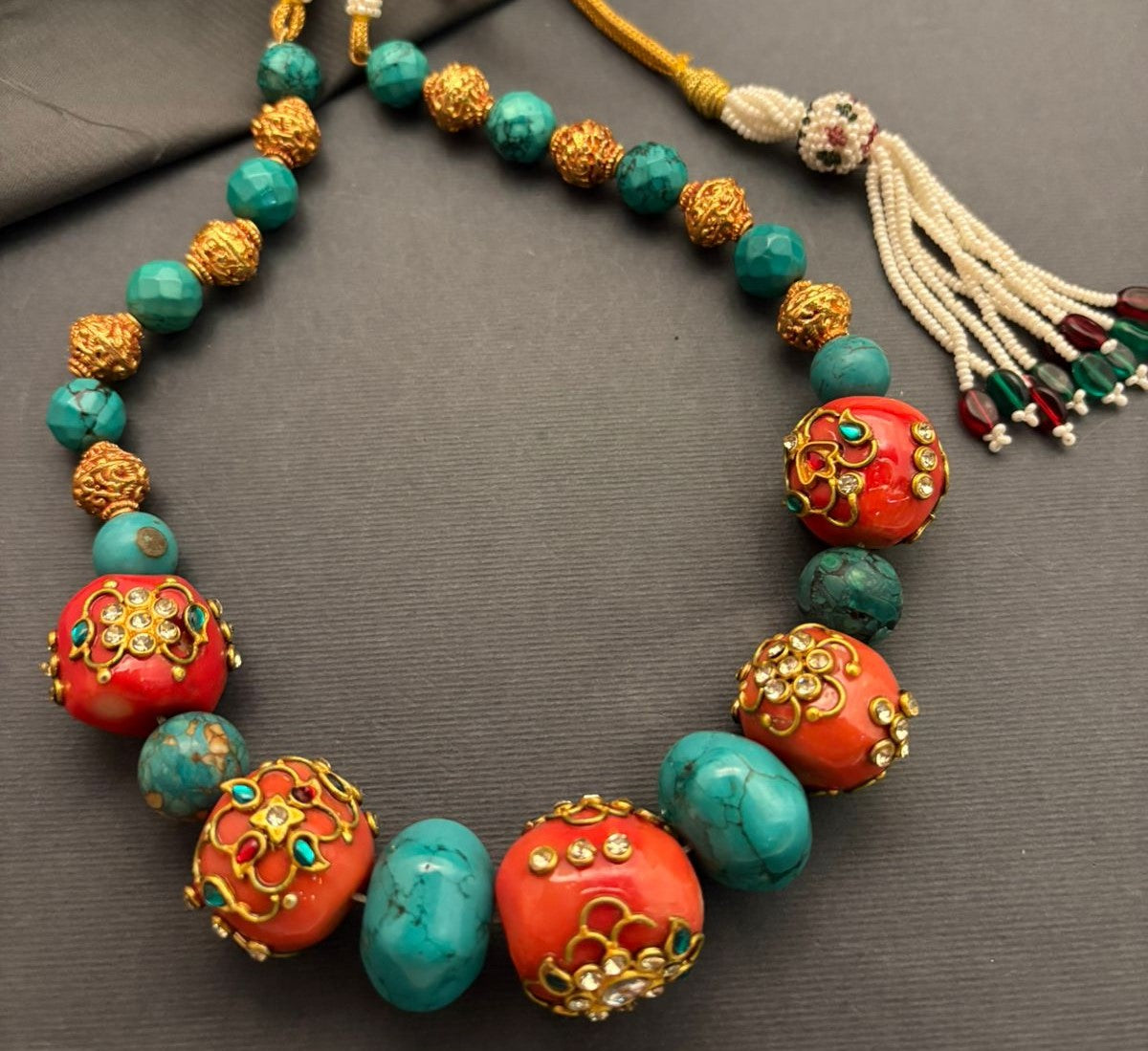 Handcrafted turquoise and coral necklace with intricate jadau work and traditional ethnic designer detailing