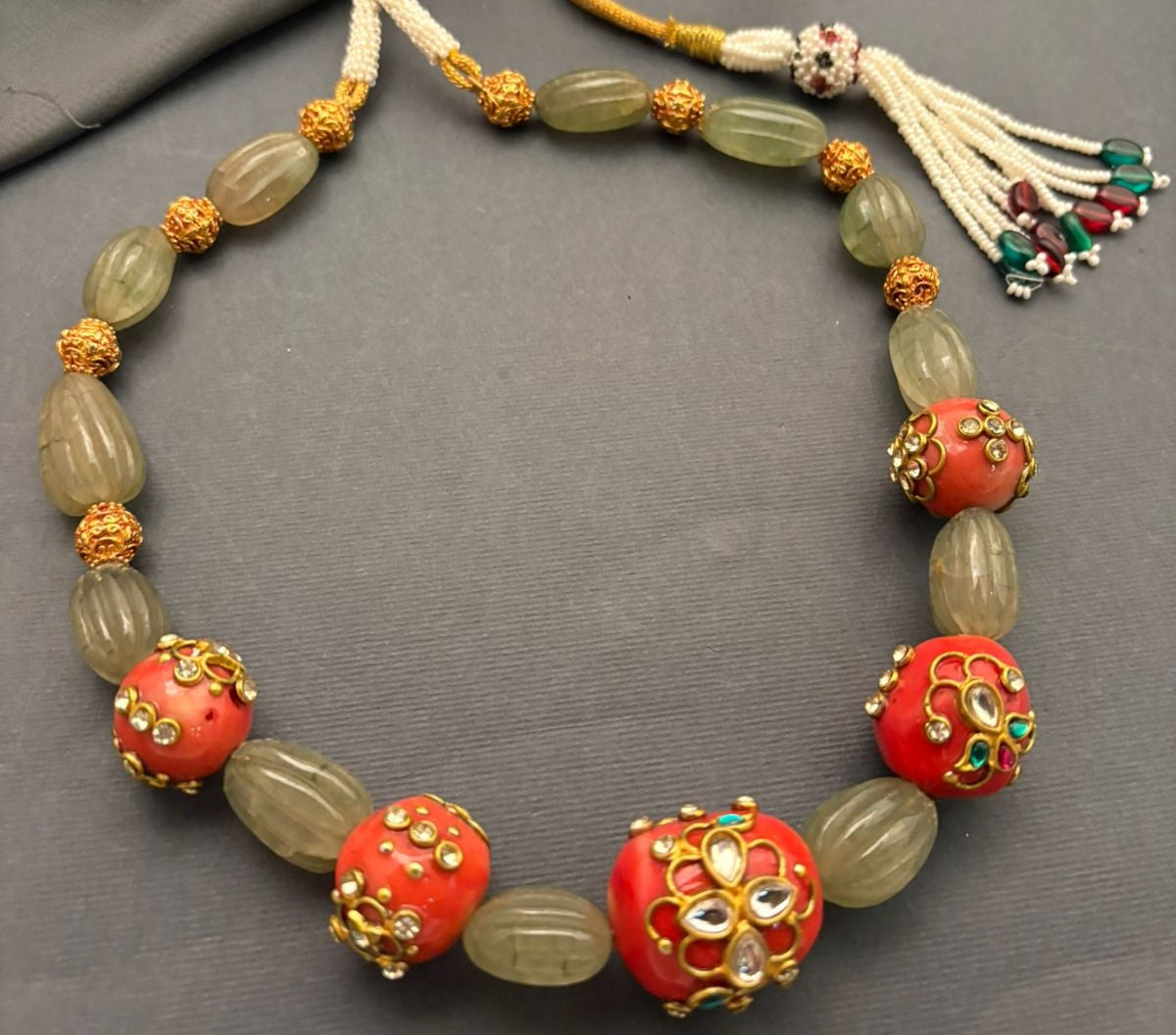 Luxury carved jade stone and coral necklace with intricate jadau work and handcrafted ethnic detailing