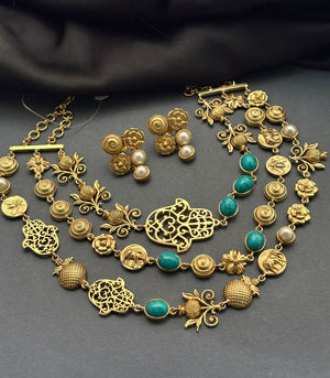 Antique gold layered necklace set with turquoise stones, floral motifs, heritage charms, and matching stud earrings displayed on a jewellery bust