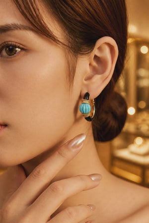 Earring with carved stone with black enamel