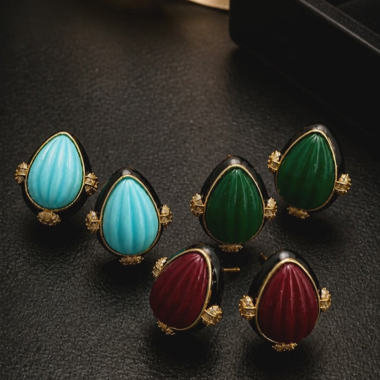 Earring with carved stone with black enamel