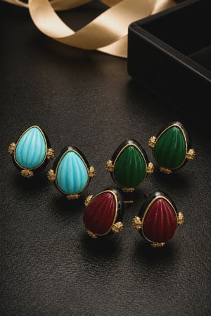 Earring with carved stone with black enamel