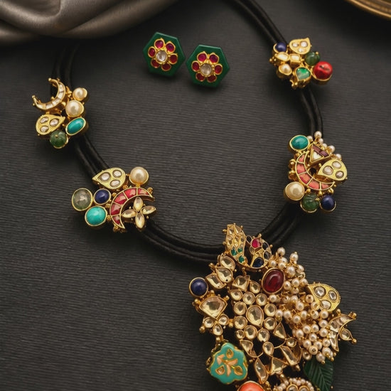 Coloured stone & jadau motif stone in a black cord