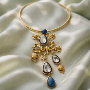 Designer gold hasli necklace with lion motif, kundan crystal detailing, and lapis stone pendant in ethnic statement style