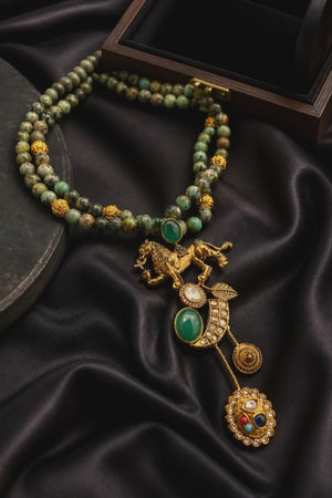 Designer lion motif necklace with kundan crystal detailing and greenish turquoise bead strands in traditional ethnic jewellery style