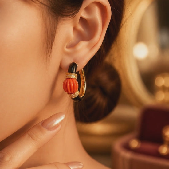Earring with carved stone with black enamel