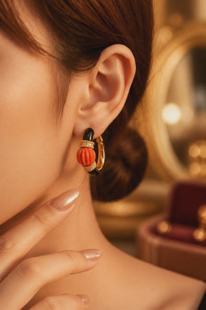 Earring with carved stone with black enamel