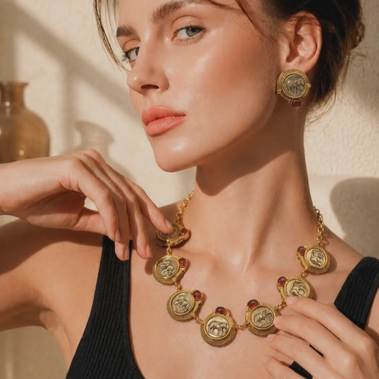 Vintage coin necklace with red stone accents and two tone polish detailing with matching earrings in ethnic statement style
