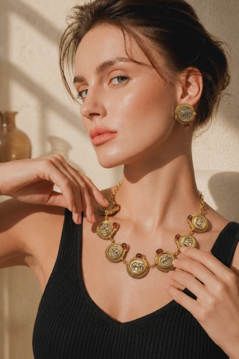 Vintage coin necklace with red stone accents and two tone polish detailing with matching earrings in ethnic statement style