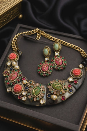 Handcrafted resin necklace with coloured stones, kundan detailing, floral accents, and matching earrings in ethnic statement jewellery style