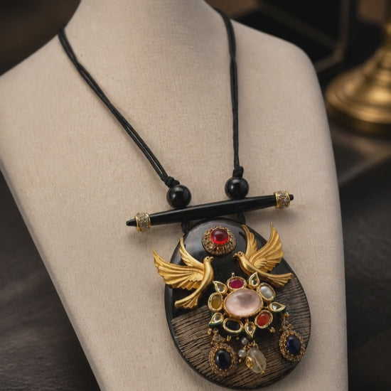 Resin pendant with bird motif and kundan and coloured stones