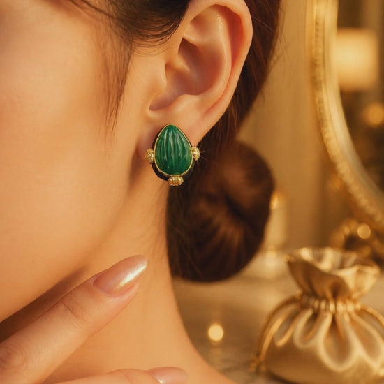 Earring with carved stone with black enamel